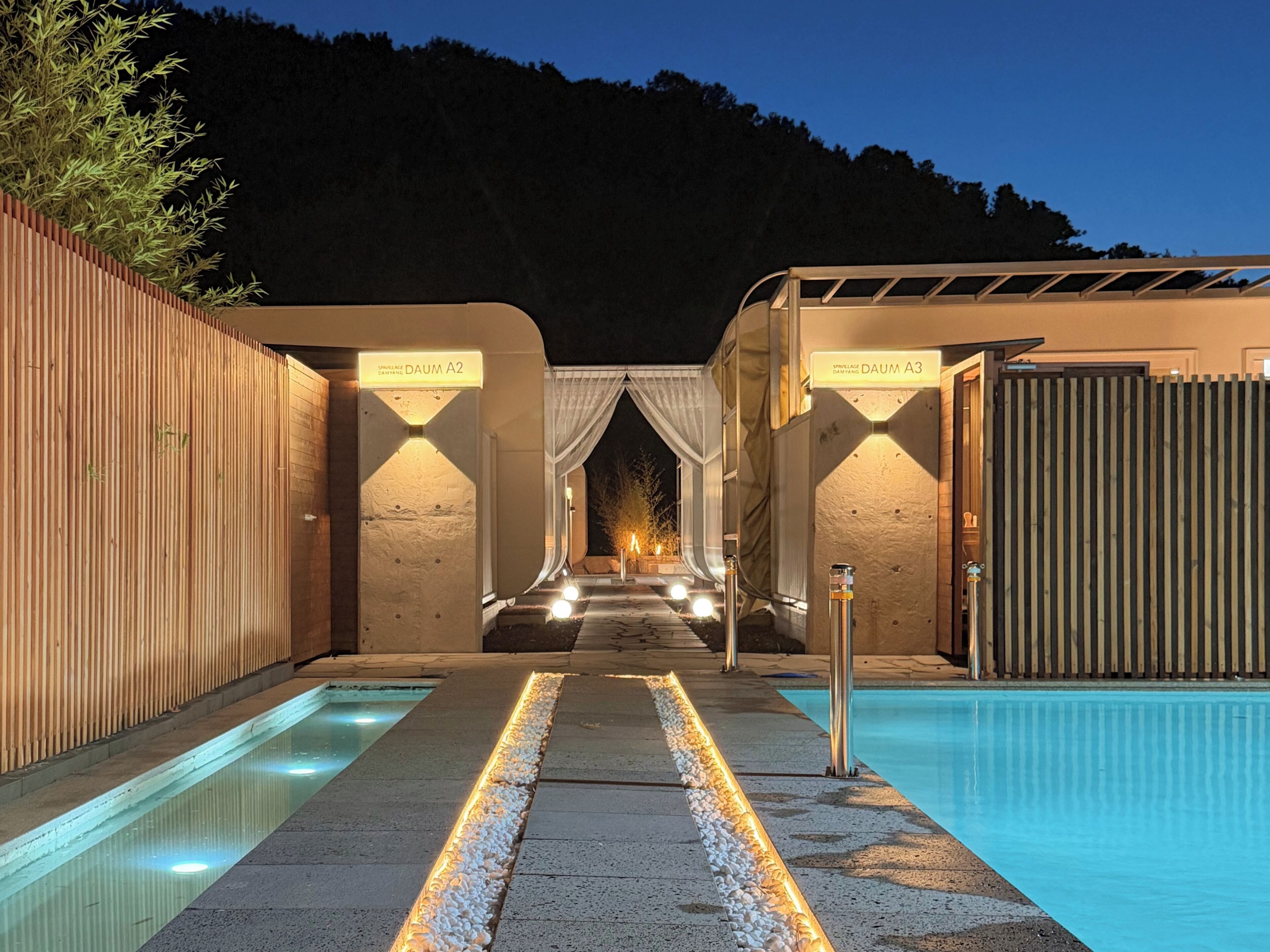 A pool area with two separate sections, each marked by a sign indicating their name.