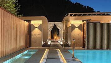 A pool area with two separate sections, each marked by a sign indicating their name.