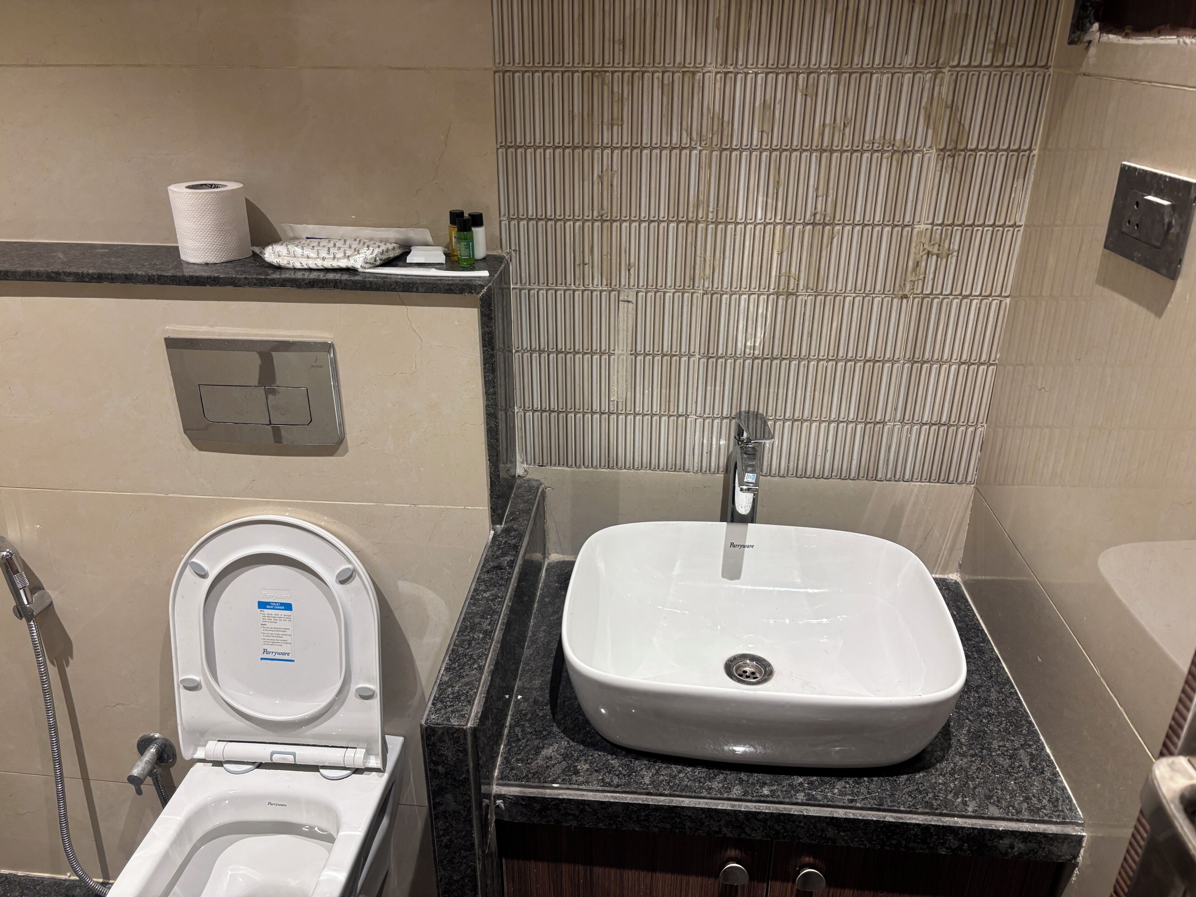 A bathroom with a toilet, sink, and shower.