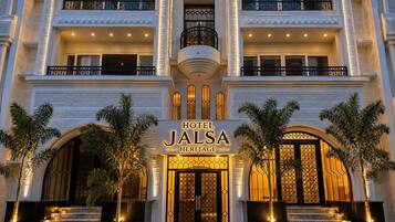 A multi-story hotel with a prominent entrance, balconies, and a sign reading 'HOTEL JALSA HERITAGE'.