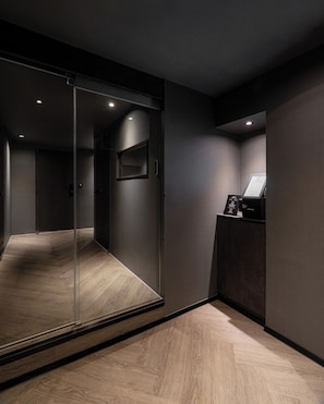 A modern elevator with a glass door, a control panel, and a wooden floor. - ONUA Gwangalli (Busan)