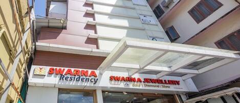 A building with a sign for 'Swarna Residency' and 'Swarna Jewellery' on the ground floor.