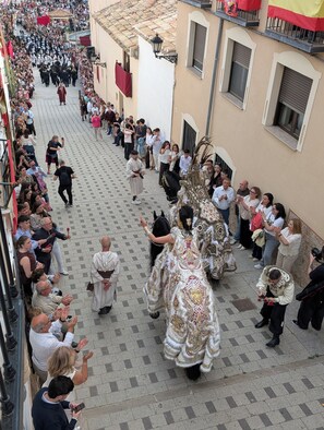 A street parade with participants in traditional costumes.