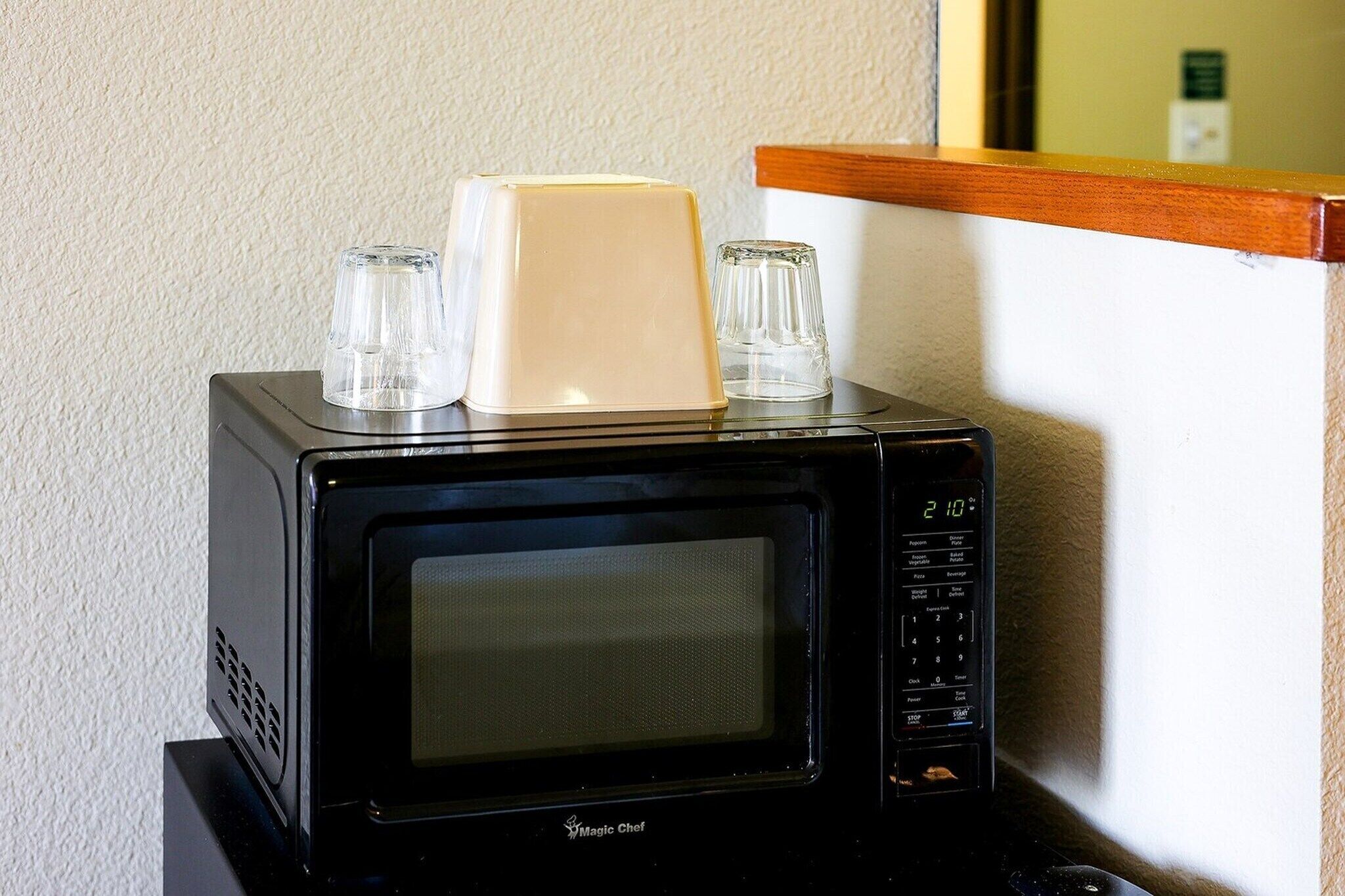 A black microwave oven with a digital display, a control panel, and a brand name visible.