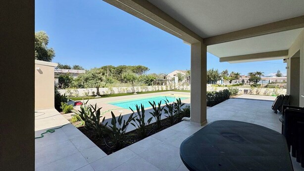 A covered patio with a pool, outdoor seating, and a view of the surrounding landscape. - Villa in Augusta with 3 bedrooms sleeps 8 (Augusta)