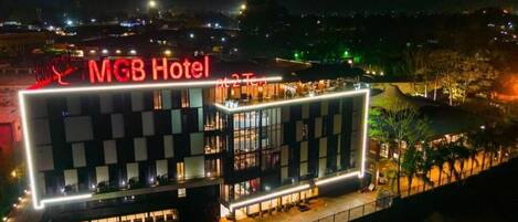 A hotel with a modern design, featuring a prominent 'MGB Hotel' sign.