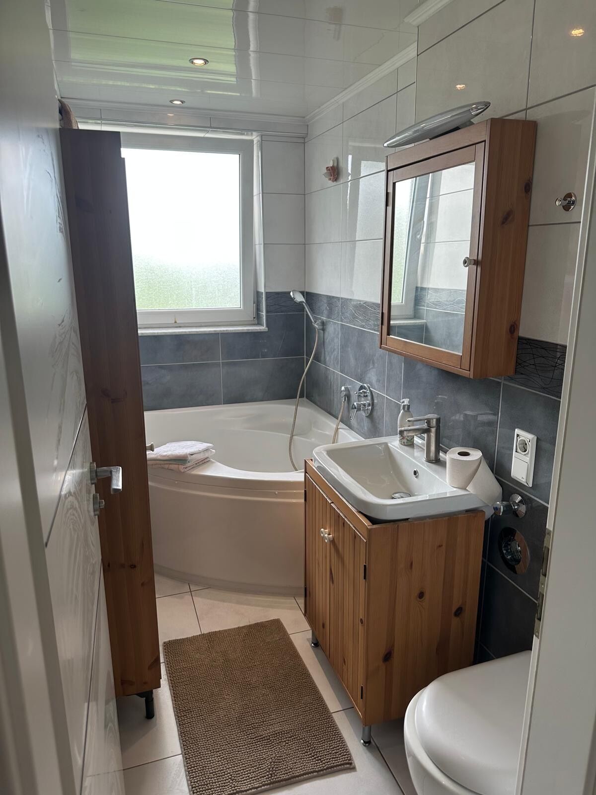 Ein modernes Badezimmer mit Badewanne, Waschbecken und Toilette.