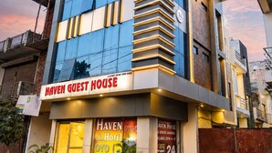 A modern hotel with a prominent 'HAVEN GUEST HOUSE' sign, a 24-hour service apartment, and a 24-hour hotel with 30 meters of length.