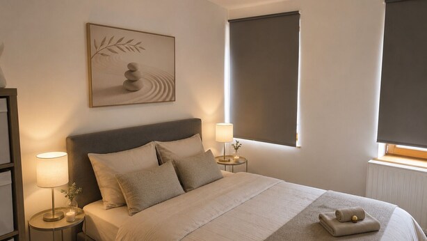 A neatly arranged bedroom with a bed, two bedside tables, a wall-mounted artwork, a window with a blind, and a radiator. - The cozy little house in Theux, near Spa, the F1 circuit, and other attractions (Theux)