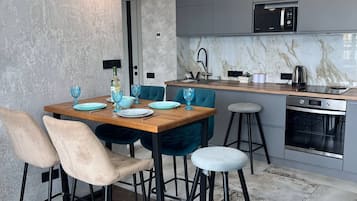 Luxury Apartment, Balcony, City View | Private kitchen | Electric kettle, griddle, cleaning supplies, freezer