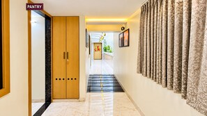 A hallway with a wooden door labeled 'PANTRY,' a 'WELCOME' sign, and patterned curtains. - The Valoria, Vijay Nagar, Indore (Indore)