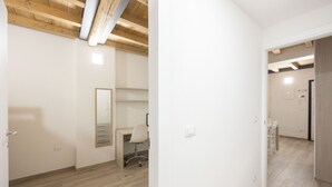 A room with a wooden ceiling, a desk, a chair, and a mirror. - Borgo San Pietro Garden (Bologna)