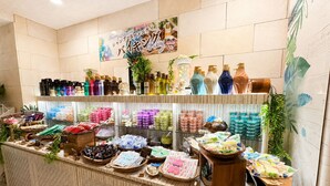 A well-organized retail display with various products, including bottles and packaged goods, arranged on shelves and counters. - Hotel BaliBali Sendai (Sendai)