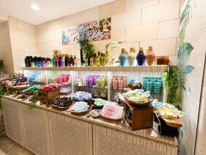 A well-organized retail display with various products, including bottles and packaged goods, arranged on shelves and counters.