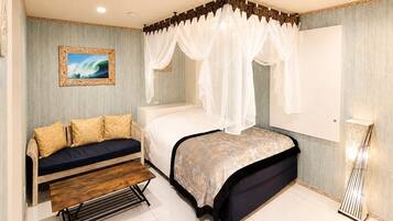 A bedroom with a canopy bed, a sofa, a bench, a painting, and a lamp.