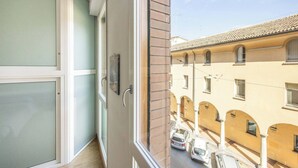 A narrow balcony with a view of a street and adjacent buildings. - Lame Pro (Bologna)