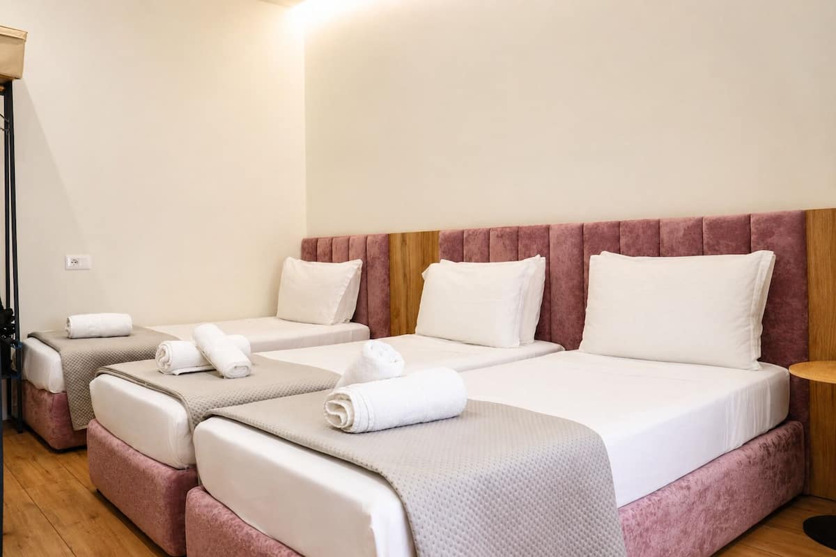 Deluxe Triple Room, Courtyard View | Desk, laptop workspace, WiFi (free), bed sheets