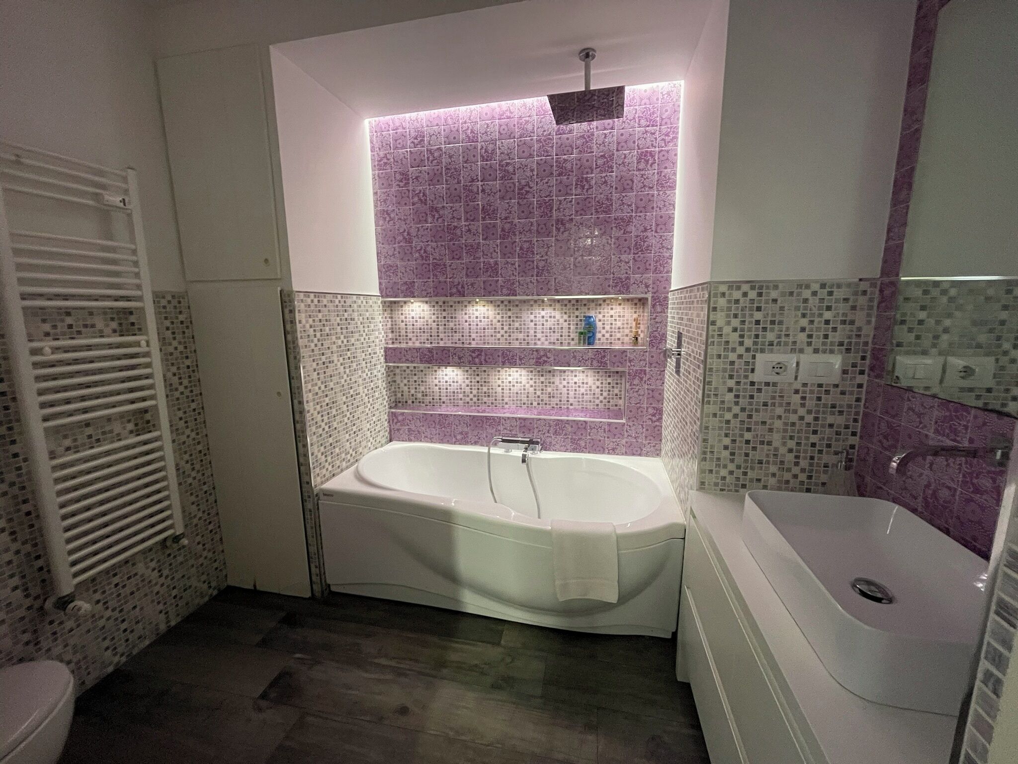 A bathroom with a freestanding bathtub, a shower, and a toilet.