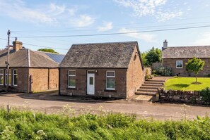 A two-story stone house with a small front garden, a visible chimney, and a paved driveway. - Home in Perth and Kinross (Coupar Angus)
