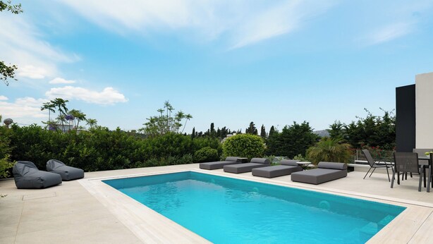 A rectangular pool with grey lounge seating and a patio area with a table and chairs. - Rosa D'oro (Maritsa)