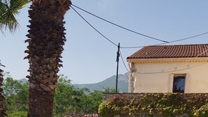 A swimming pool with a stone wall and a tiled roof structure. - GRAPI Farm with a swim spa for 4 adults and 4 children (CALVI)