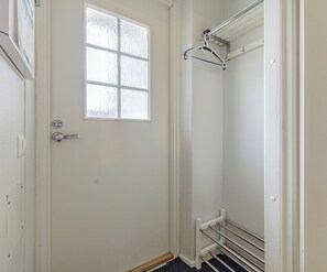 A bathroom with a white door, a window, a towel rack, and a shower area. - Levistar 912 - 2BR Apt with Sauna (Kittilä)