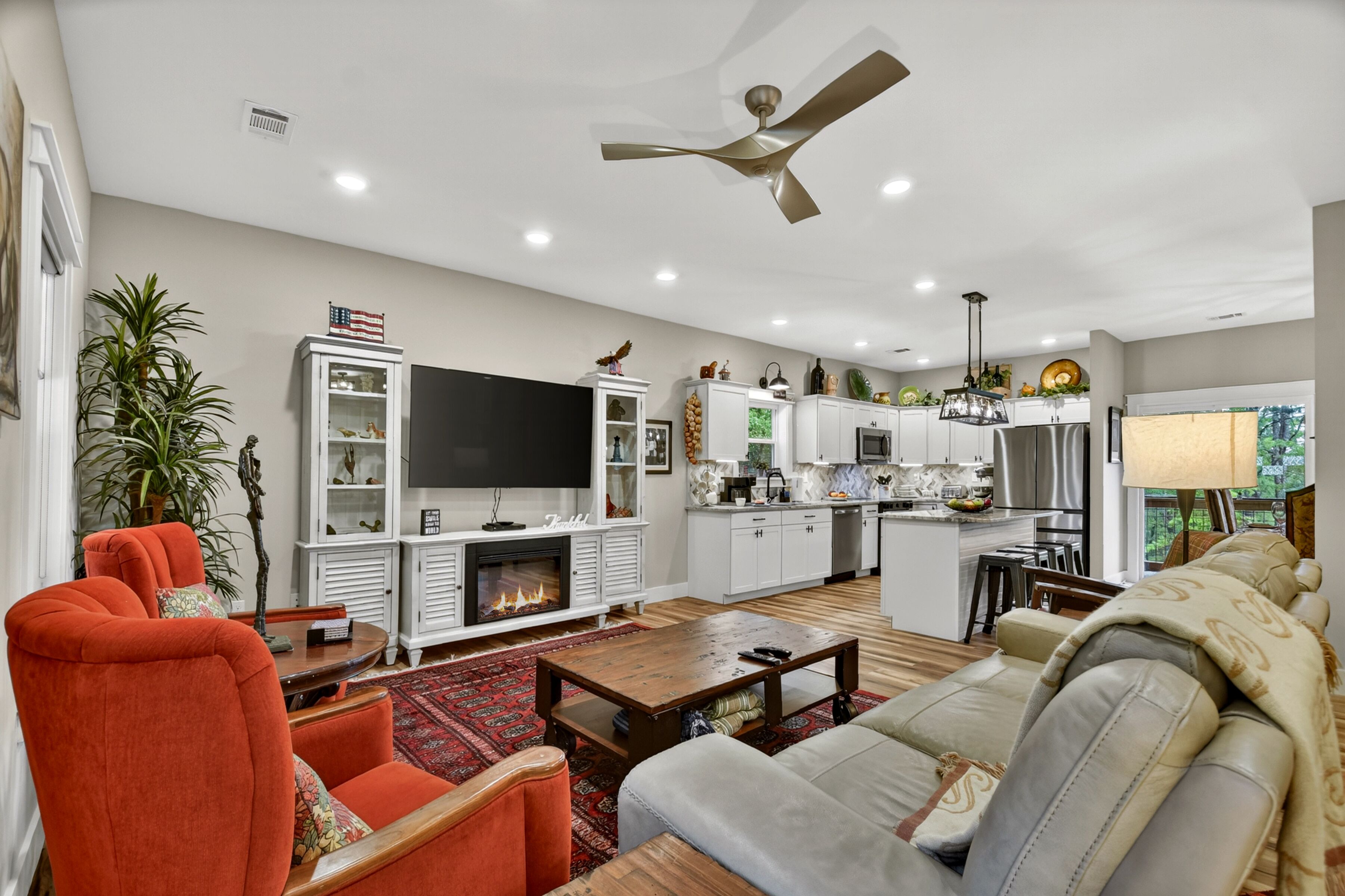 A modern living room with a fireplace, television, and seating area.
