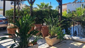 A covered outdoor area with a pergola, potted plants, and a car parked nearby. - Villa Koryfi - Argaka - 3 Bedroom villa minutes walk from the beach (6 guests) (Argaka)