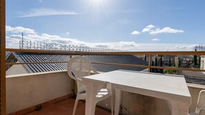 A balcony with a table and chairs, a view of the cityscape, and a clear sky. - Classic Riviera Escape With Pool, Grasse (Grasse)