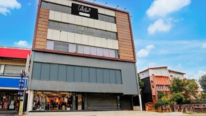A modern building with a sign that reads 'Collection' and 'Company Serviced'. - Collection O Kotdwar Railway Junction (Kotdwāra)