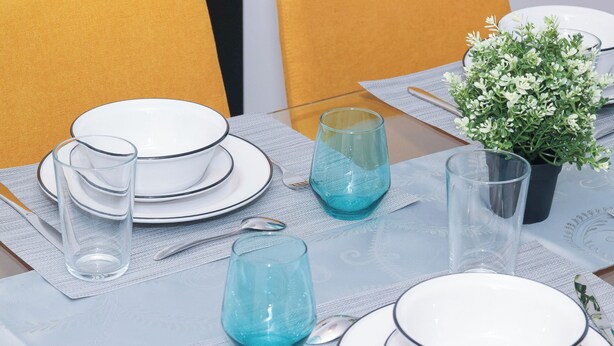 A dining table set with plates, glasses, cutlery, and a potted plant. - Stylish Home near Luxury Spa & GO Station (Whitby)