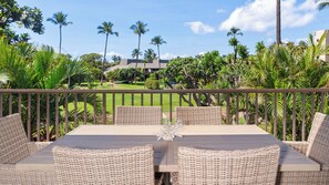 A deck with wicker furniture and a view of a golf course. - Remodeled Spacious 3bd Across From Beach I Koa Resort 2H (Kihei)