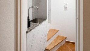 A bathroom with a marble wall, a sink, and a shower area. - Elegant 5-day loft, Milan Dateo, tricolor (Milano)