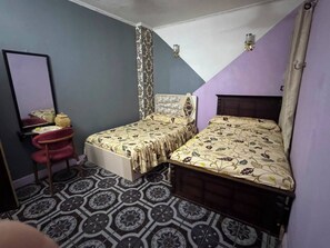 A bedroom with two beds, a chair, a mirror, and patterned flooring. - Pharaonic 2BR Apt Near Giza Pyramids GEM AC WiFi Balcony (Giza)