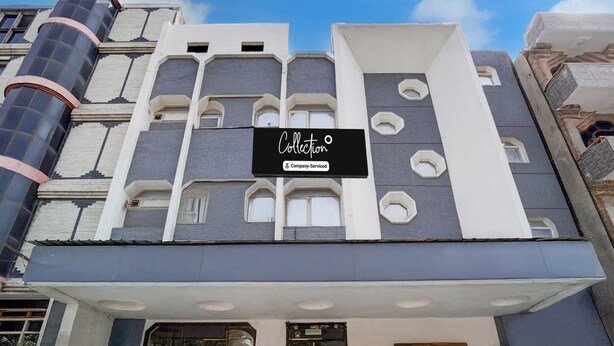 A building with a modern facade, multiple windows, and a sign that reads 'Collection Company-Serviced.' - Collection O Tourist Complex Area (Agra)
