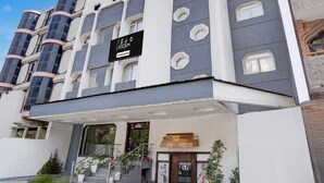 A modern building with a sign reading 'Collection Company Service.' - Collection O Tourist Complex Area (Agra)