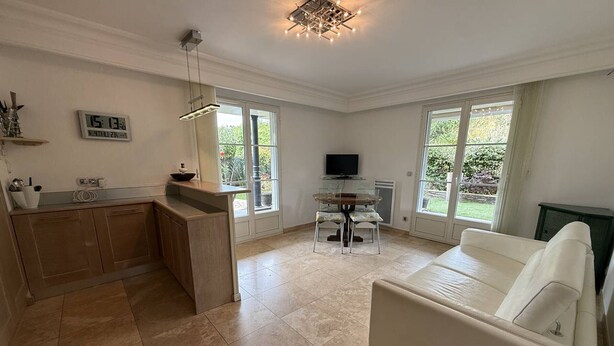 A modern kitchen with a dining area, a TV, and a sofa. - Charming apartment, air conditioning - 2 guests (La Croix-Valmer)