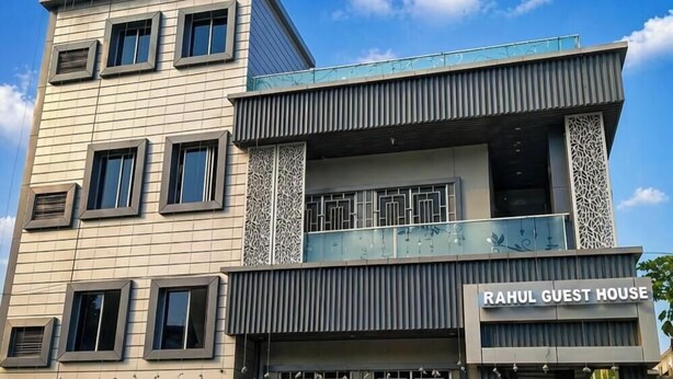 A multi-story building with a sign reading 'RAHUL GUEST HOUSE.'