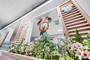 A large Mickey Mouse statue in a floral arrangement. - 9BR villa sleeps 22 with pool table in kissimmee (Kissimmee)