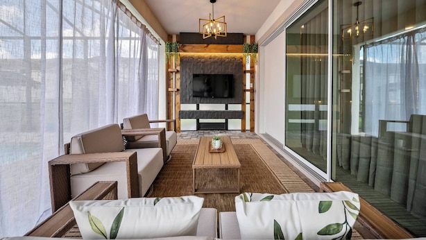 A modern living room with a fireplace, a flat-screen TV, and comfortable seating. - 9BR villa sleeps 22 with pool table in kissimmee (Kissimmee)