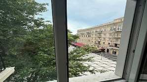 A view from a window of a building with a geometric patterned pavement outside. - La Casa Boutique Nizami (Baku)