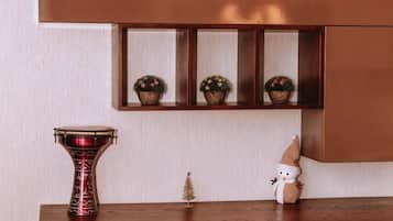 A wooden console table with a potted plant, a decorative bowl, and a small figurine.