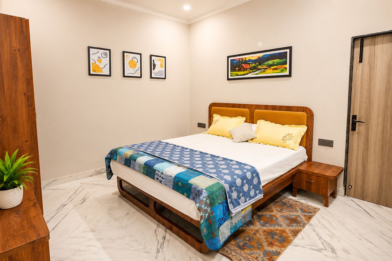 A bedroom with a bed, bedside tables, a nightstand, a potted plant, a painting on the wall, and a door.