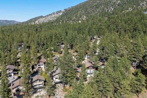 A residential area with houses surrounded by dense forest, likely a mountain region. - Tahoe Tyrol Chalet - Two Bedroom House, Sleeps 4 (South Lake Tahoe)