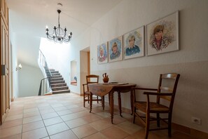 A staircase leading to a second floor, a dining area with a table and chairs, and a chandelier. - Marie-Marthe | Luxury bastide with private pool in Aups, Provence (Aups)