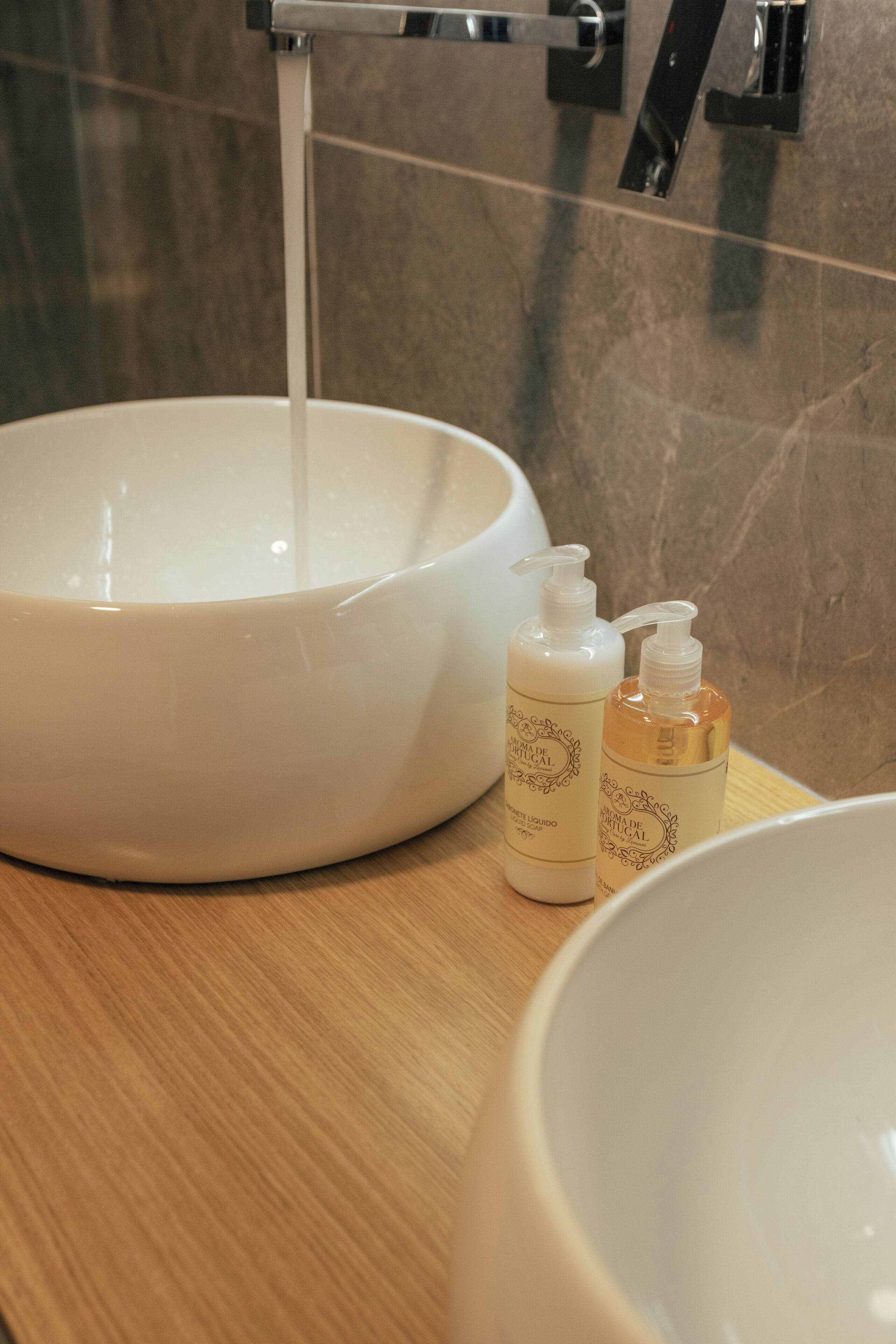 A bathroom sink with a faucet, two soap bottles, and a mirror.