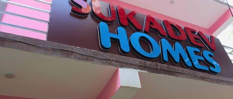 A sign for 'Sukadev Homes' with a modern design.