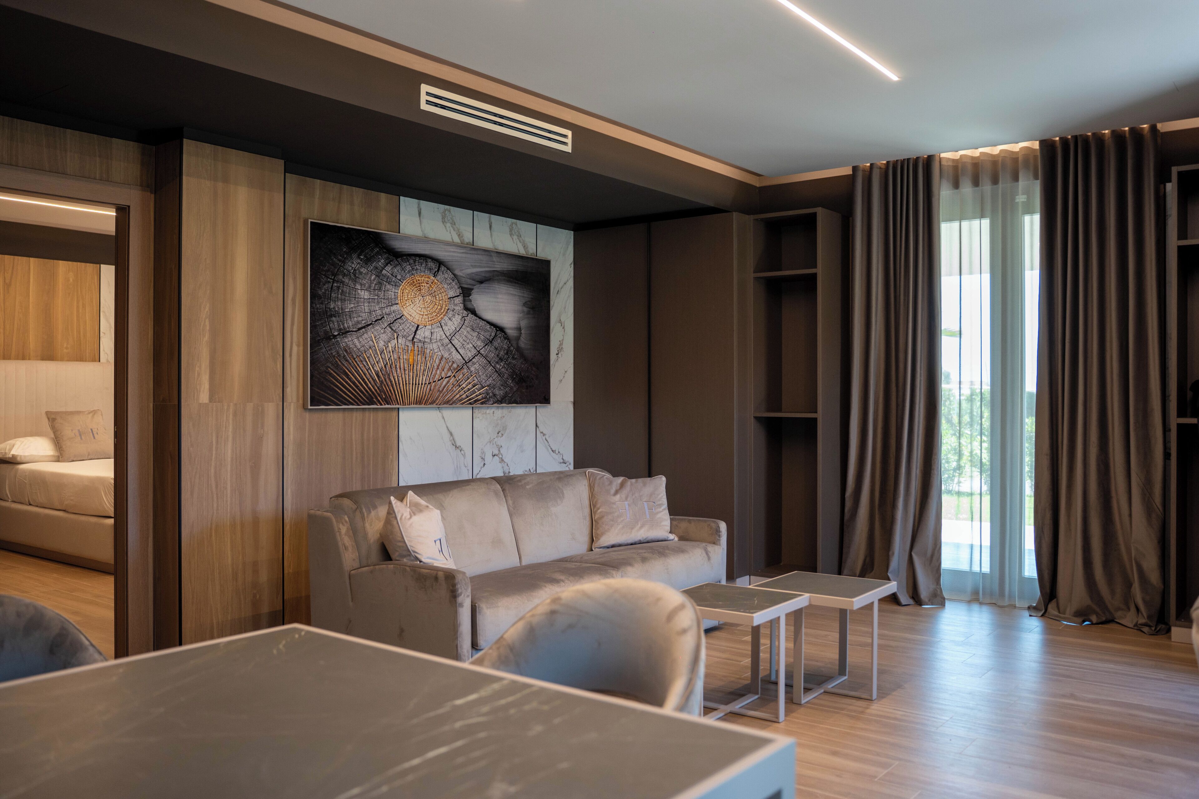 Ein modernes Wohnzimmer mit einer Couch, einem Couchtisch und einem Gemälde an der Wand.