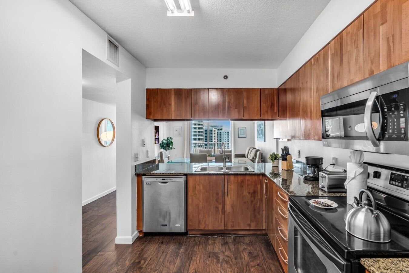 A modern kitchen with wooden cabinets, stainless steel appliances, and a dishwasher.