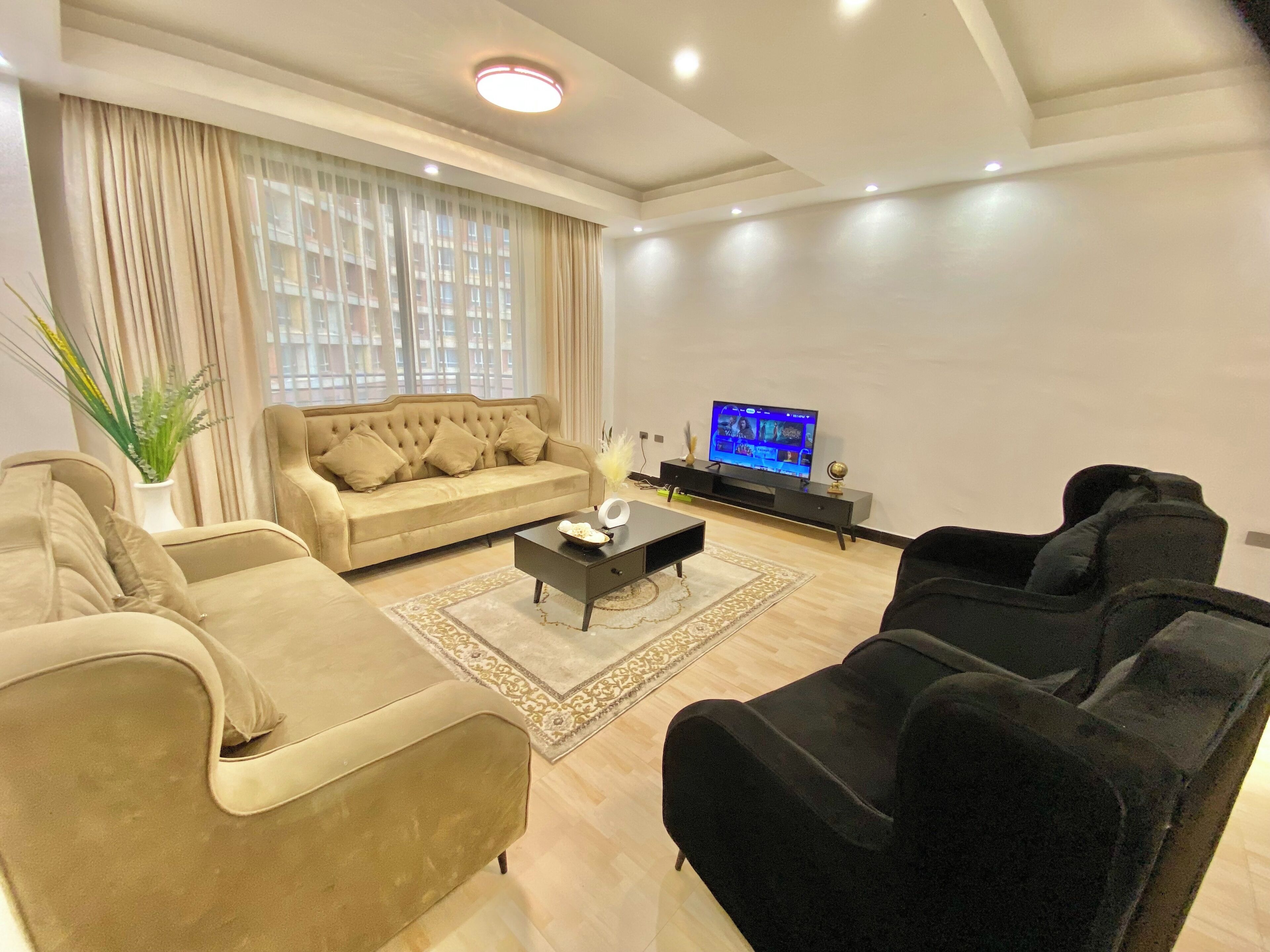 Clean, bright, and spacious living area with a Smart TV, private balcony & views